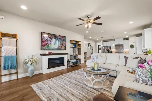 a living room with furniture a fireplace and a chandelier