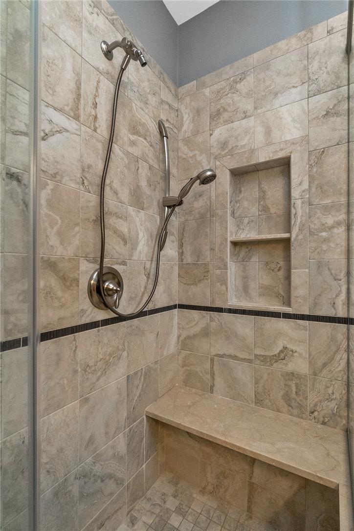 5728 Pheasant Road Bethlehem, PA 18017 - Photo 23 of 39 Floor-to-ceiling tile work and a built-in bench elevate this walk-in shower.
