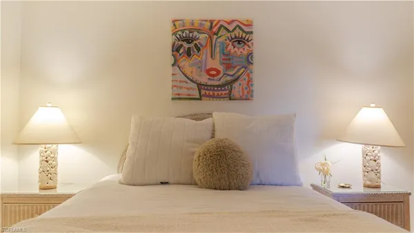 a bedroom with a bed and a lamp