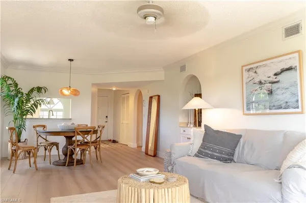 a living room with furniture a table and a chandelier
