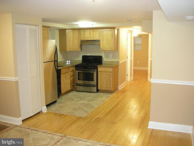 4732 Benning Road Southeast, Unit 102 Washington, DC 20019 - Photo 1 of 28 a kitchen with stainless steel appliances granite countertop a refrigerator a stove and a sink