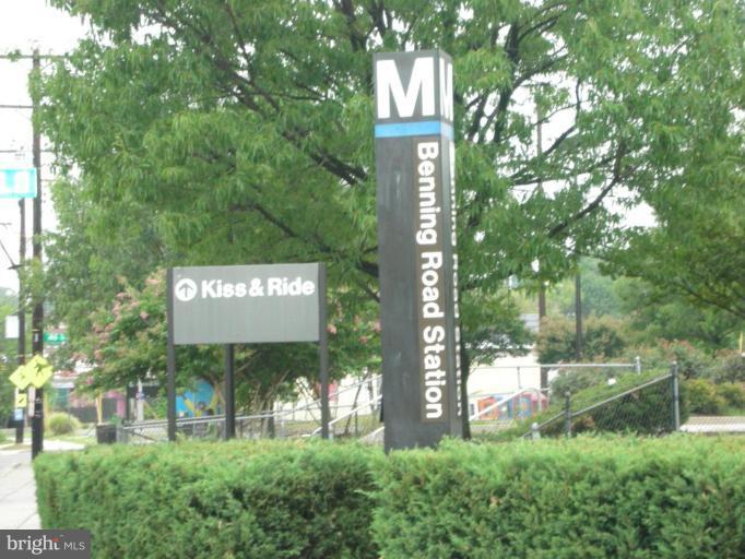 4732 Benning Road Southeast, Unit 102 Washington, DC 20019 - Photo 25 of 28 a view of a street sign under a large tree