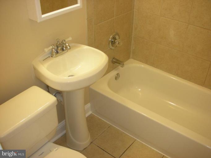 4732 Benning Road Southeast, Unit 102 Washington, DC 20019 - Photo 7 of 28 a bathroom with a sink and a toilet