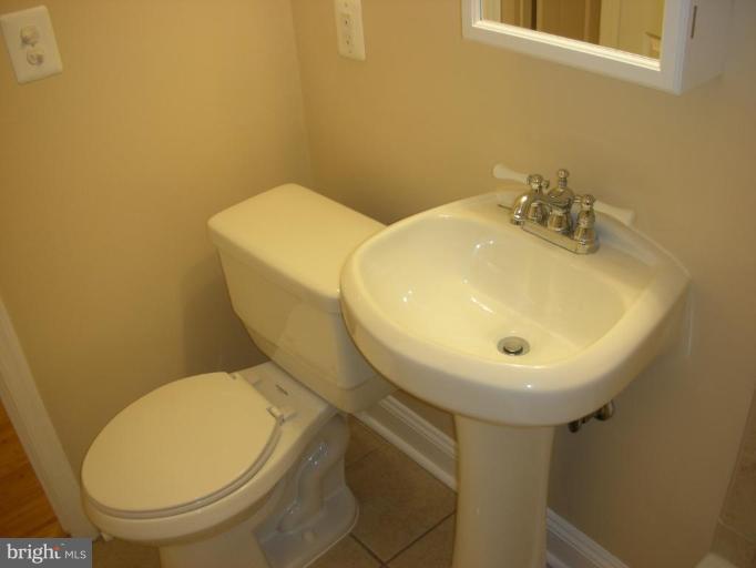 4732 Benning Road Southeast, Unit 102 Washington, DC 20019 - Photo 9 of 28 a bathroom with a sink and a toilet