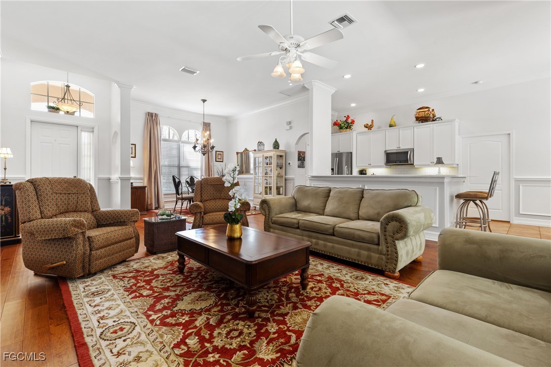 15035 Balmoral Loop Fort Myers, FL 33919 - Photo 12 of 39 a living room with furniture and a chandelier