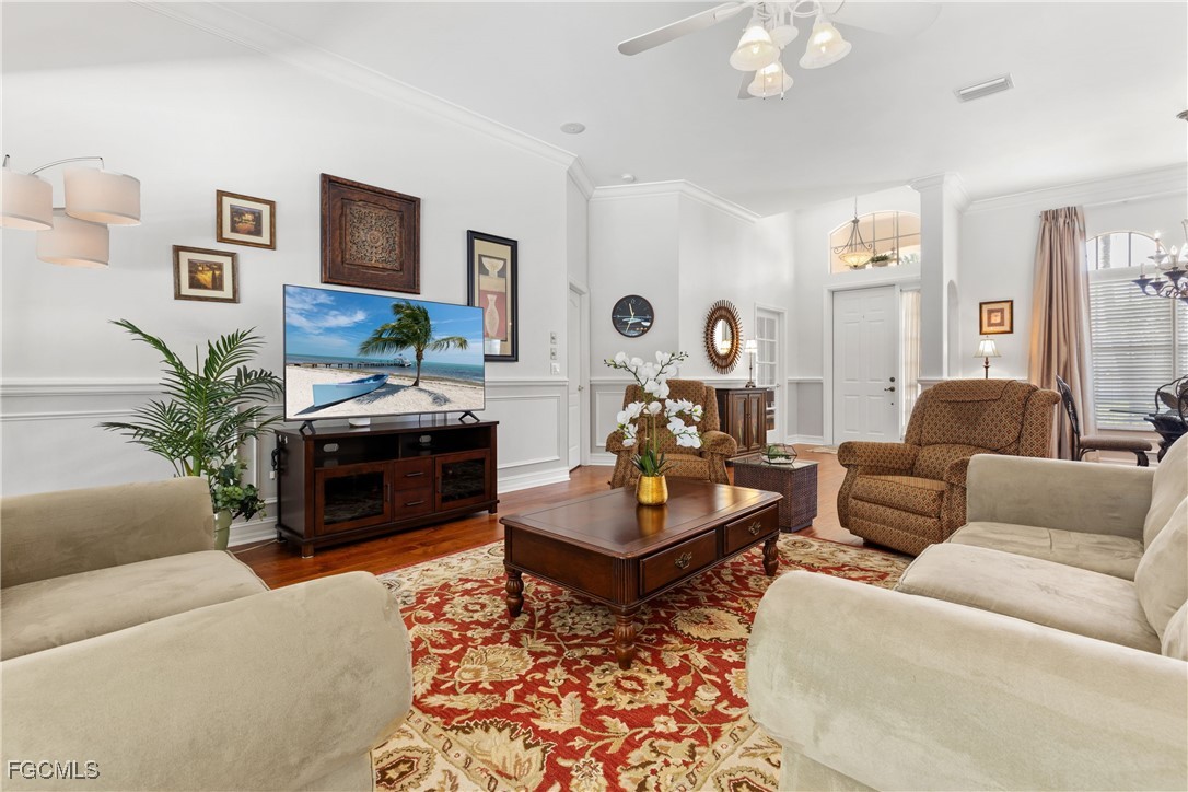 15035 Balmoral Loop Fort Myers, FL 33919 - Photo 13 of 39 a living room with furniture a flat screen tv and a fireplace