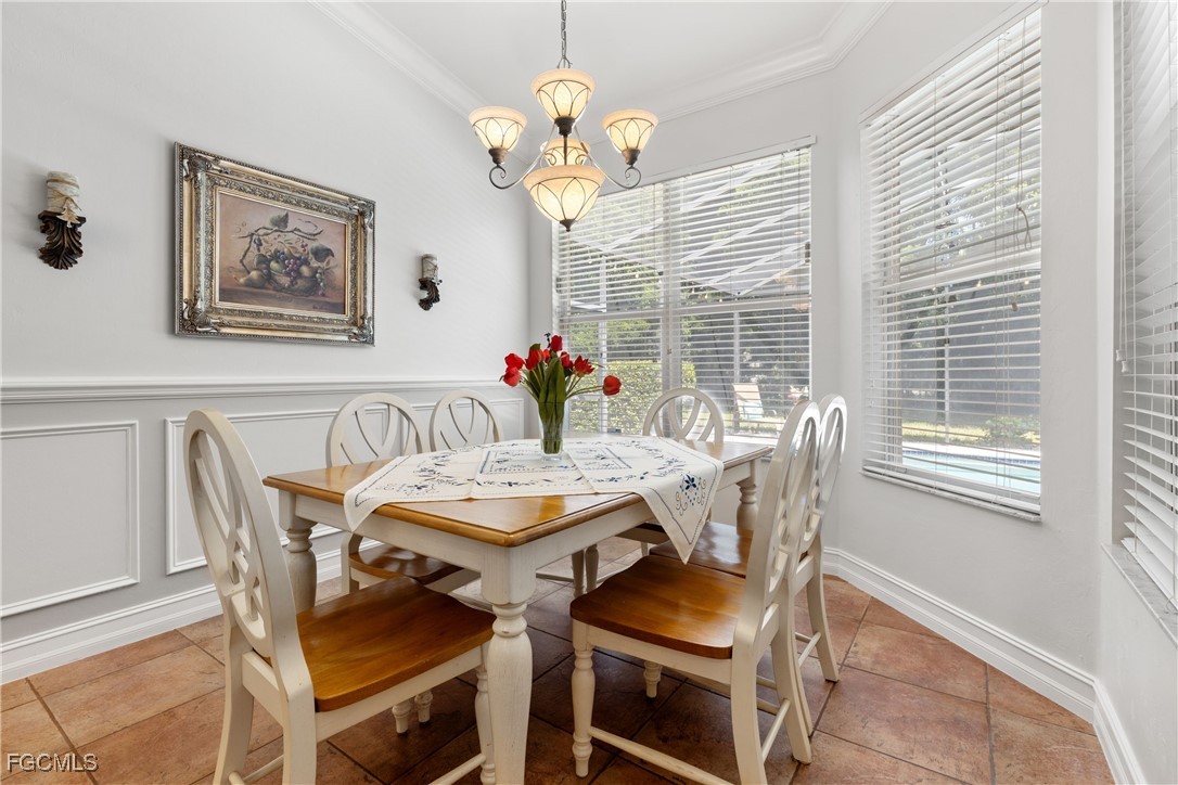 15035 Balmoral Loop Fort Myers, FL 33919 - Photo 14 of 39 a view of a dining room with furniture wooden floor and a chandelier