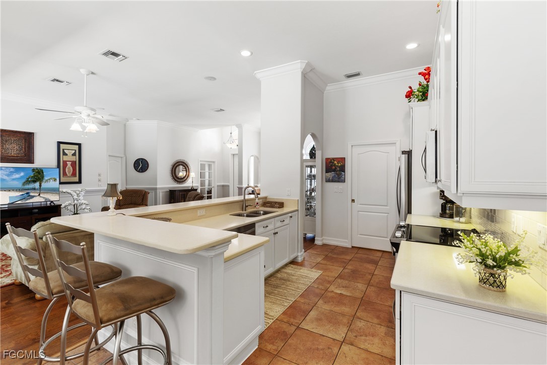15035 Balmoral Loop Fort Myers, FL 33919 - Photo 16 of 39 a large kitchen with a table and chairs