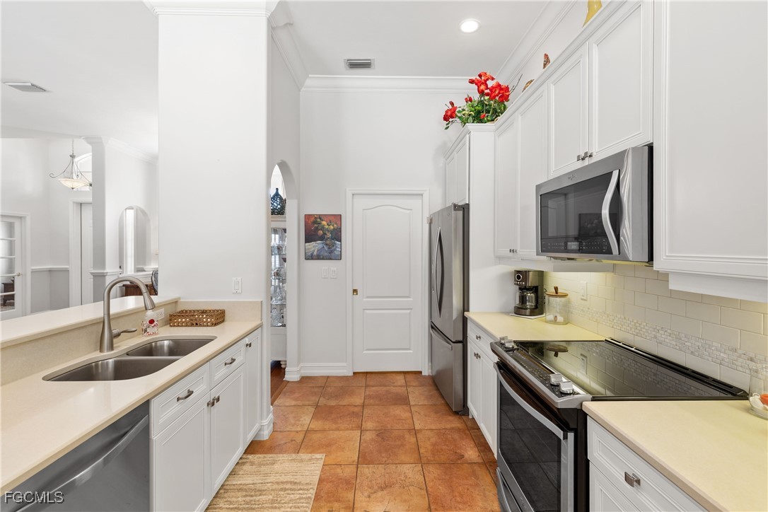 15035 Balmoral Loop Fort Myers, FL 33919 - Photo 17 of 39 a kitchen with a sink stove and refrigerator