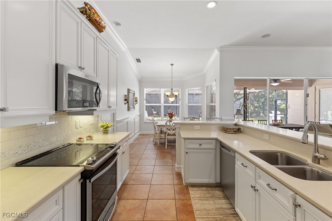 15035 Balmoral Loop Fort Myers, FL 33919 - Photo 19 of 39 a kitchen that has a sink and a stove in it