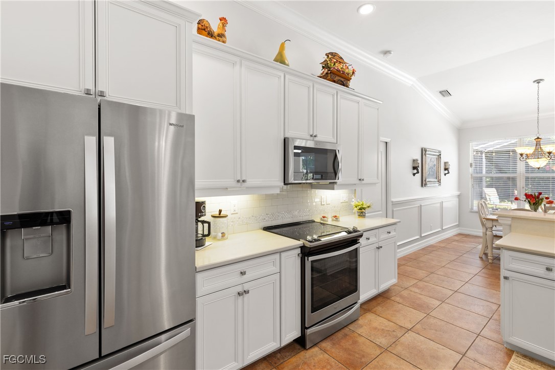 15035 Balmoral Loop Fort Myers, FL 33919 - Photo 20 of 39 a kitchen with stainless steel appliances a refrigerator sink and microwave