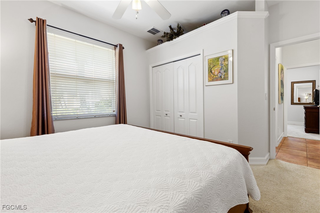 15035 Balmoral Loop Fort Myers, FL 33919 - Photo 23 of 39 a bedroom with a bed and a window