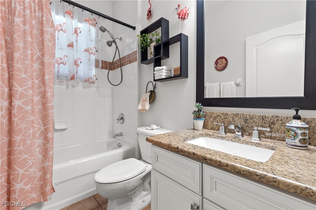 15035 Balmoral Loop Fort Myers, FL 33919 - Photo 24 of 39 a bathroom with a granite countertop sink a toilet and shower