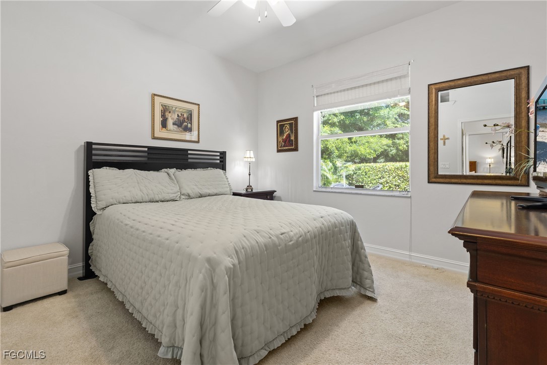 15035 Balmoral Loop Fort Myers, FL 33919 - Photo 25 of 39 a bed sitting in a bedroom next to a window