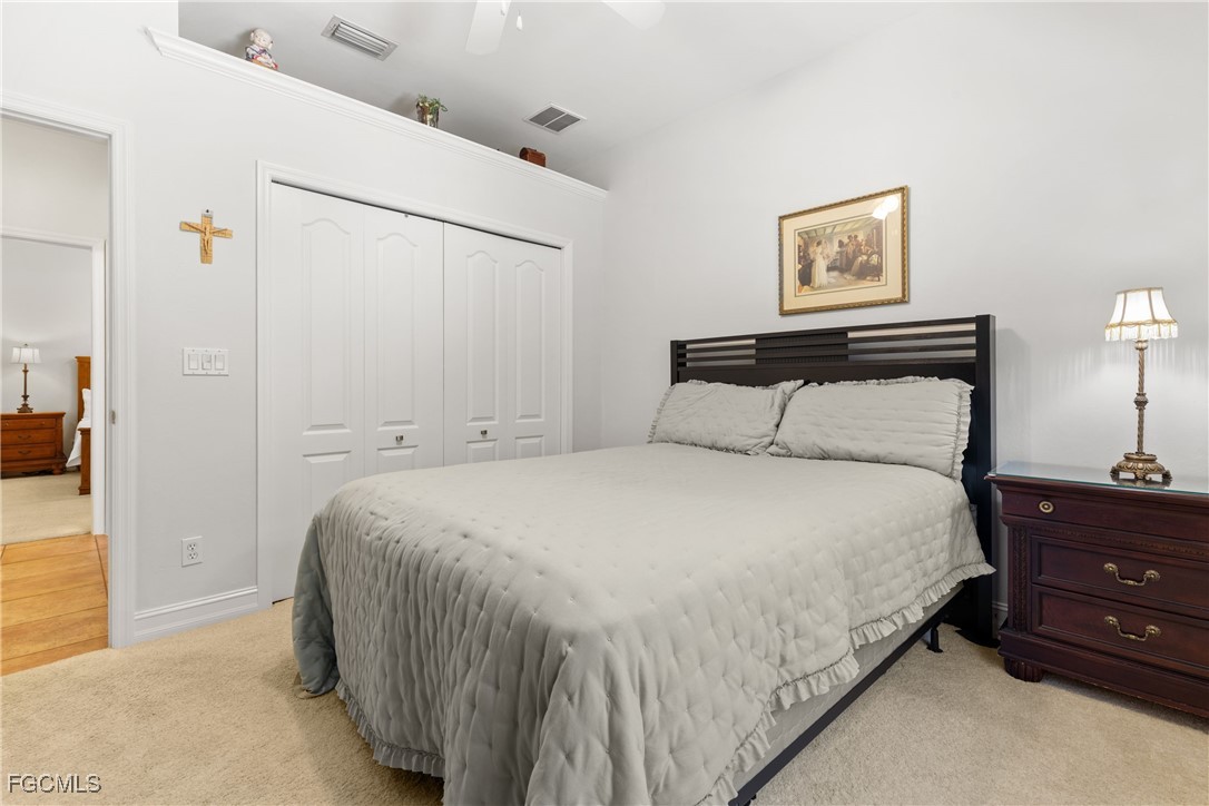 15035 Balmoral Loop Fort Myers, FL 33919 - Photo 26 of 39 a bedroom with a bed and a night stand