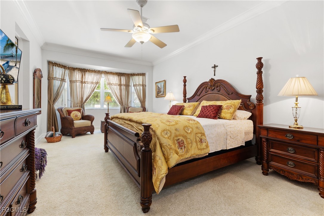 15035 Balmoral Loop Fort Myers, FL 33919 - Photo 27 of 39 a spacious bedroom with a bed and a chandelier