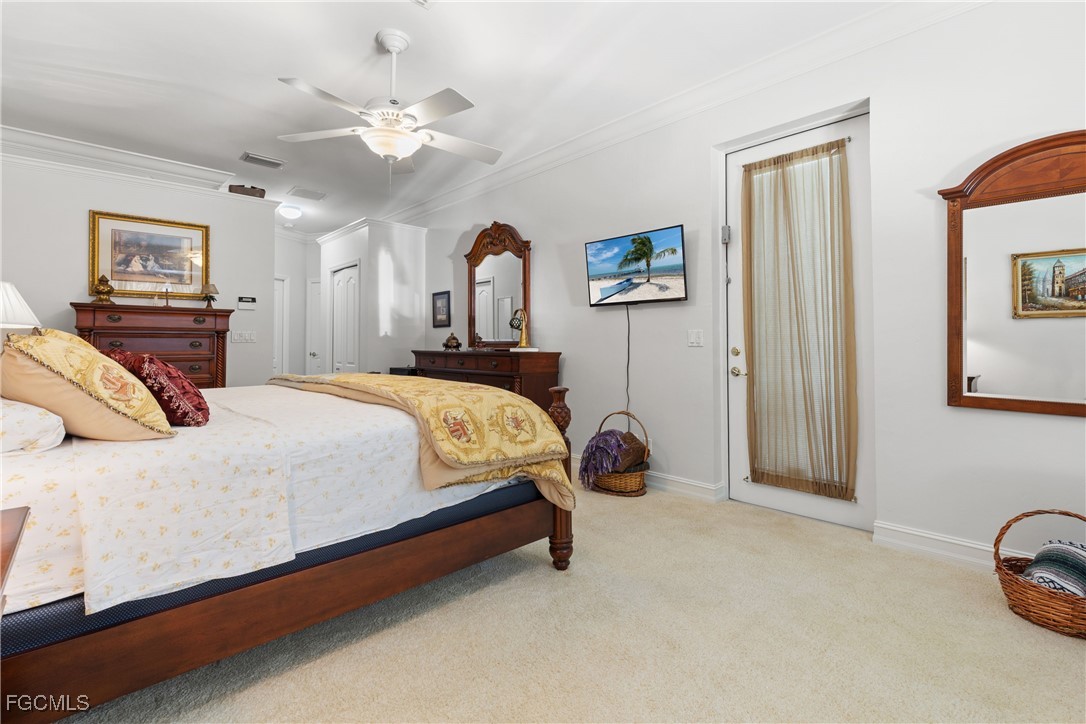 15035 Balmoral Loop Fort Myers, FL 33919 - Photo 29 of 39 a bedroom with a bed a couch and a chandelier