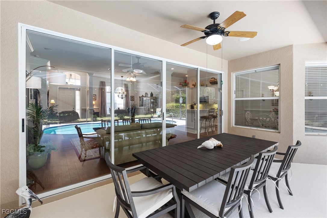 15035 Balmoral Loop Fort Myers, FL 33919 - Photo 34 of 39 a view of a dining room with furniture wooden floor and a chandelier