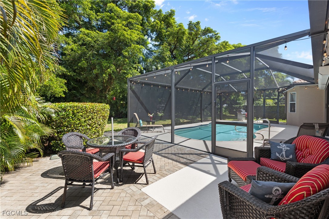 15035 Balmoral Loop Fort Myers, FL 33919 - Photo 37 of 39 a view of a patio with couches and chairs under an umbrella