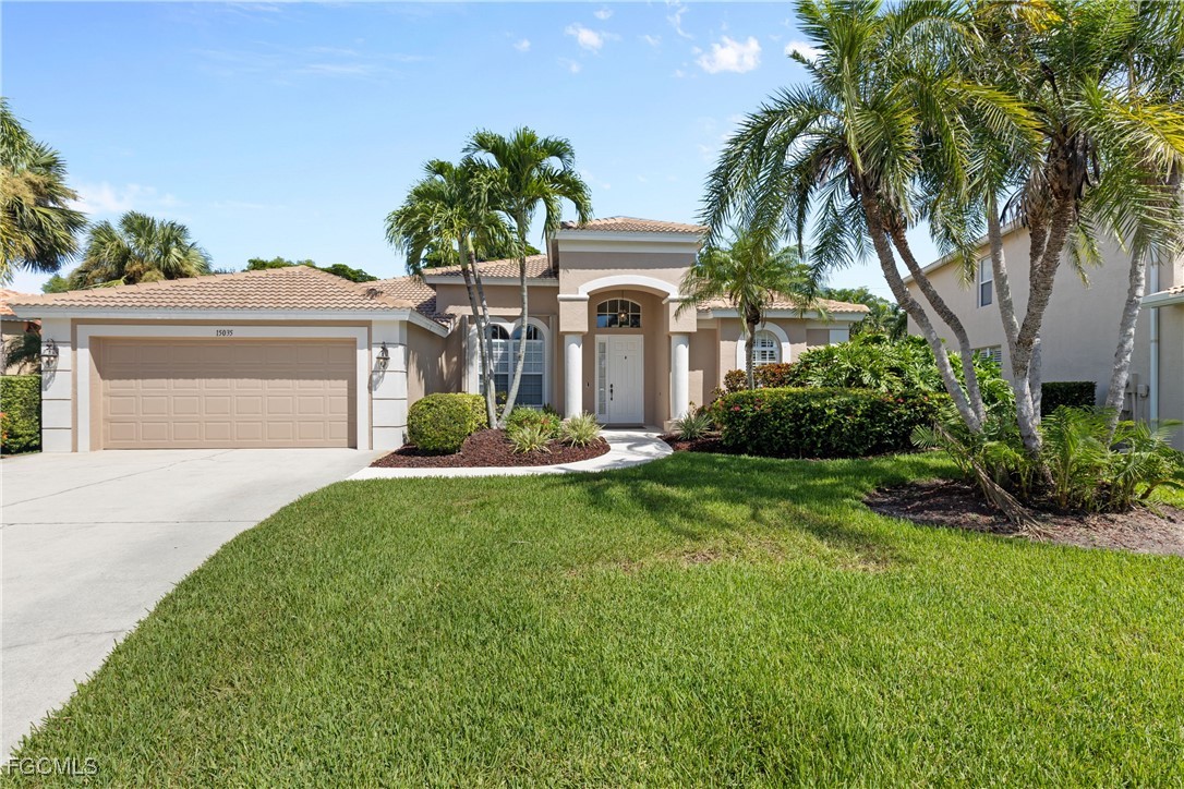 15035 Balmoral Loop Fort Myers, FL 33919 - Photo 4 of 39 a front view of a house with a yard and garage