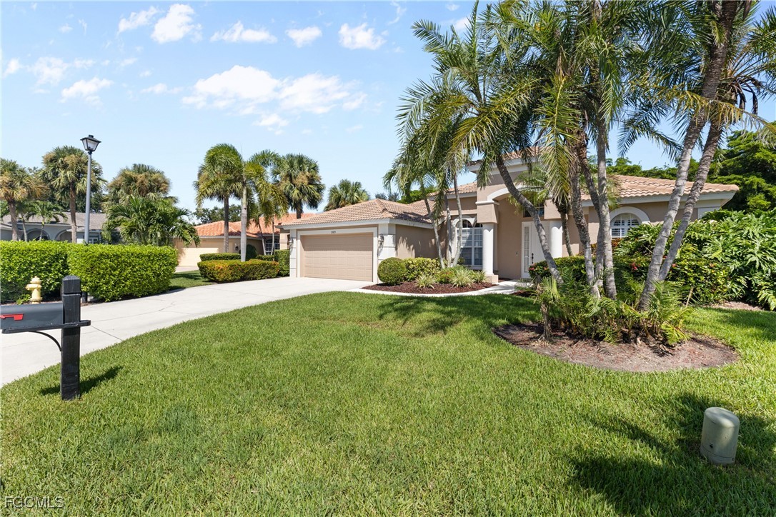 15035 Balmoral Loop Fort Myers, FL 33919 - Photo 5 of 39 a view of a house with a yard and potted plants
