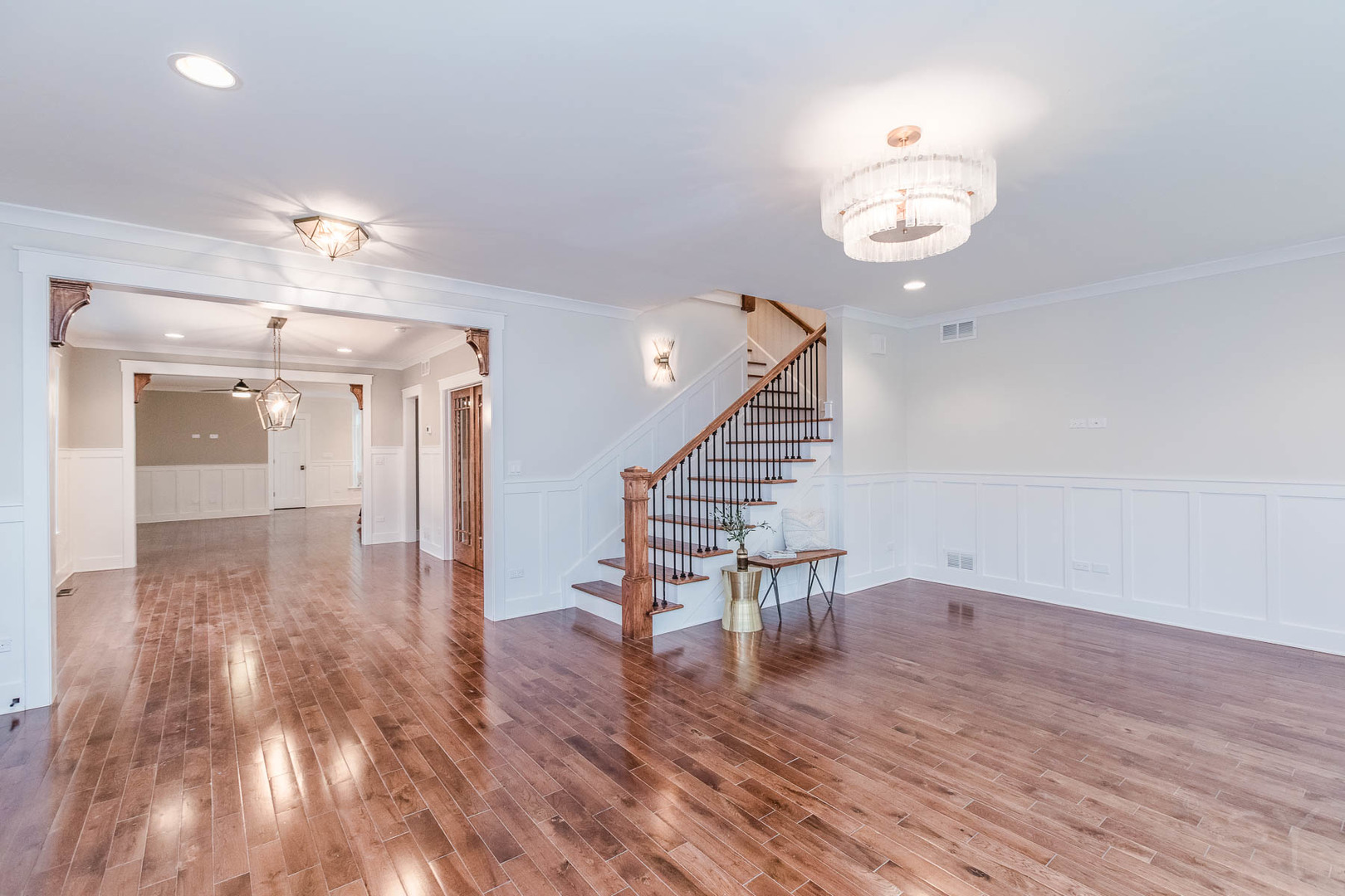 271 Lawton Road Riverside, IL 60546 - Photo 4 of 29 an empty room with wooden floor and staircase