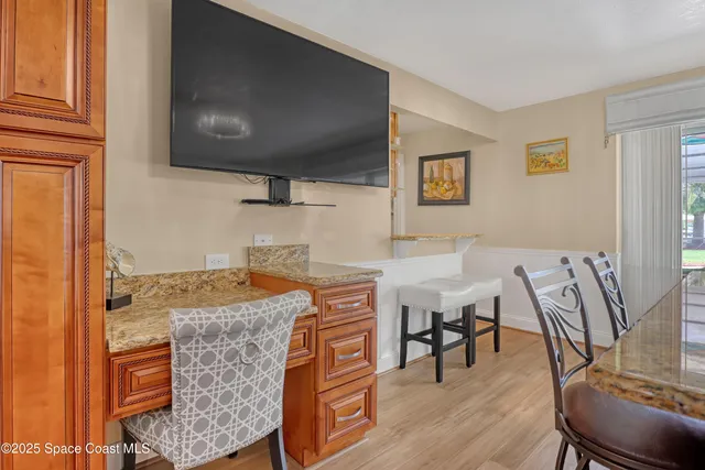 a kitchen with stainless steel appliances granite countertop a sink and a refrigerator