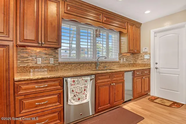 a kitchen with a refrigerator a stove a sink and cabinets
