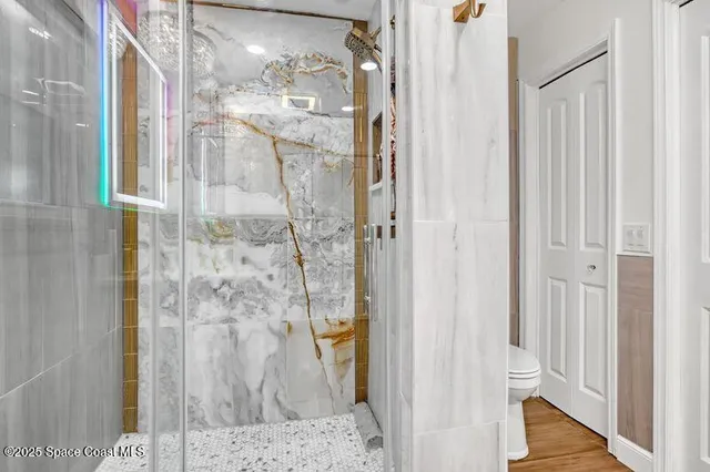 a bathroom with a granite countertop shower and a sink