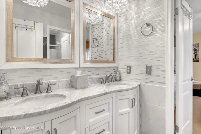 a bathroom with double vanity sink a mirror and shower