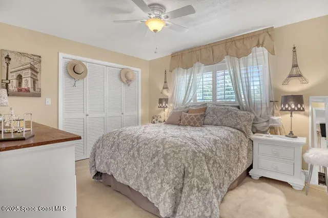 a living room with furniture fireplace and a large window