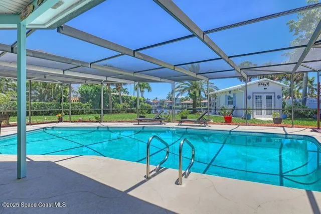 a view of a patio with a table and chairs under an umbrella