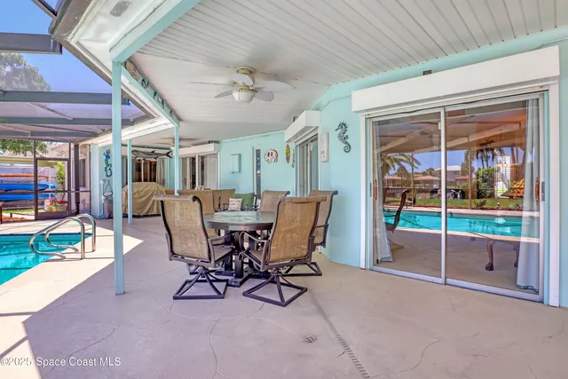 a view of a chair and table in backyard of the house