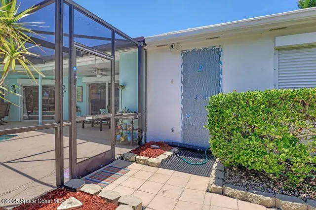 a view of a swimming pool with a patio and a yard
