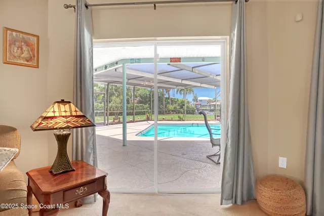 a living room with furniture and a floor to ceiling window