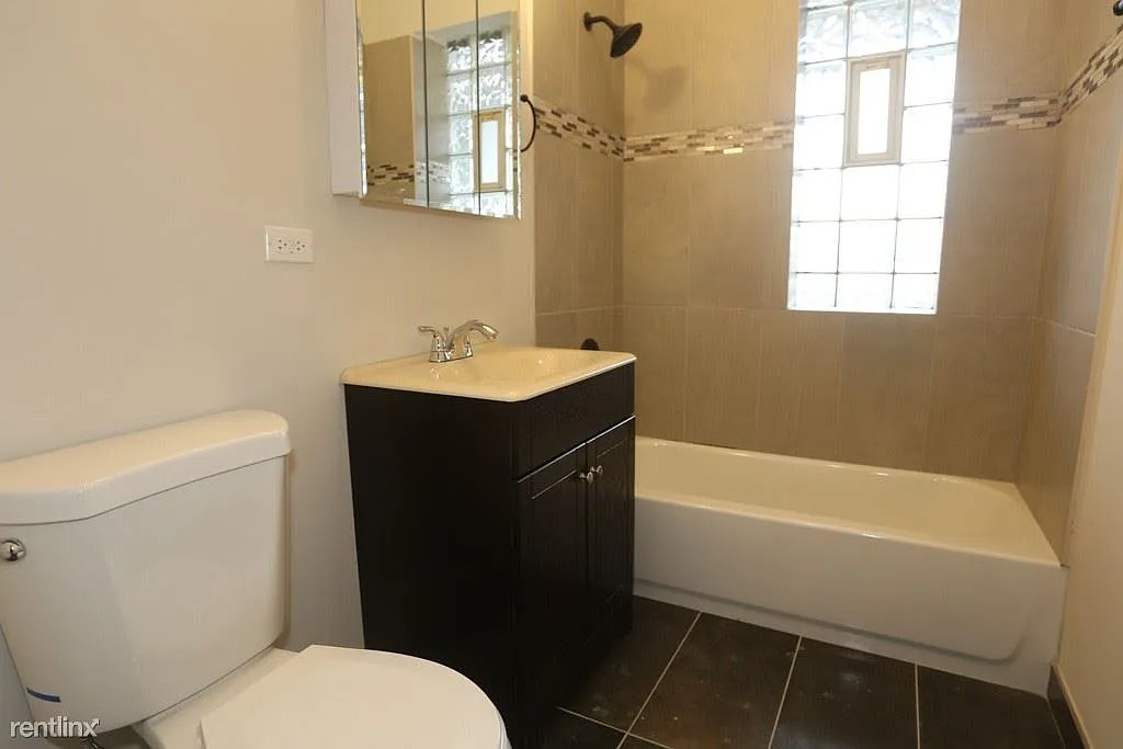 3916 West Altgeld Street, Unit 1 Chicago, IL 60647 - Photo 18 of 18 a bathroom with a sink toilet and shower