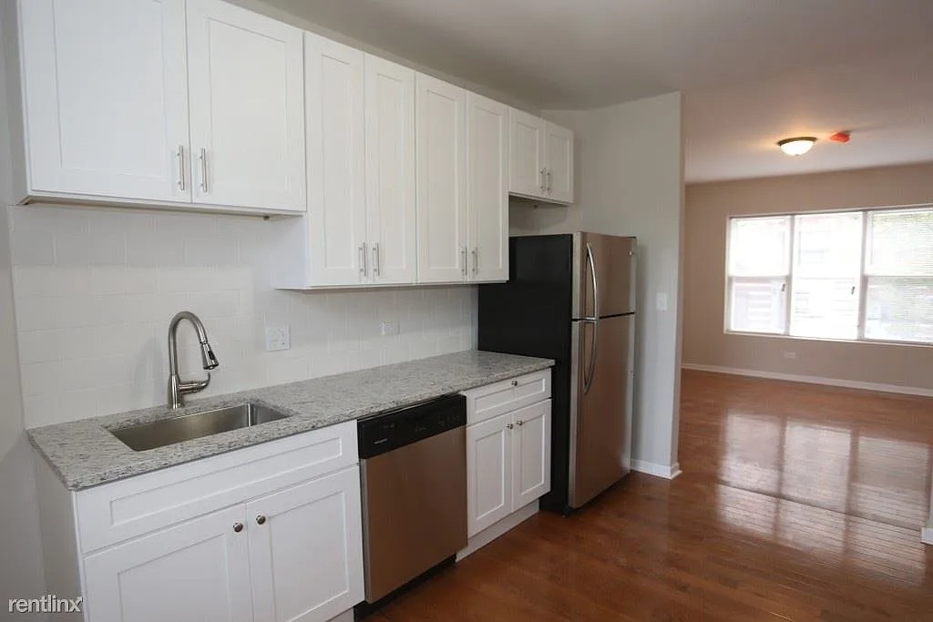 3916 West Altgeld Street, Unit 1 Chicago, IL 60647 - Photo 7 of 18 a kitchen with stainless steel appliances granite countertop a refrigerator sink and cabinets