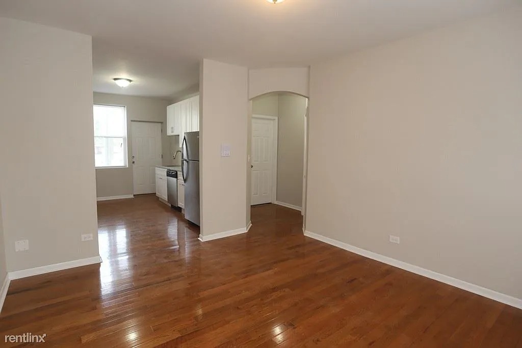 3916 West Altgeld Street, Unit 1 Chicago, IL 60647 - Photo 8 of 18 a view of empty room with wooden floor