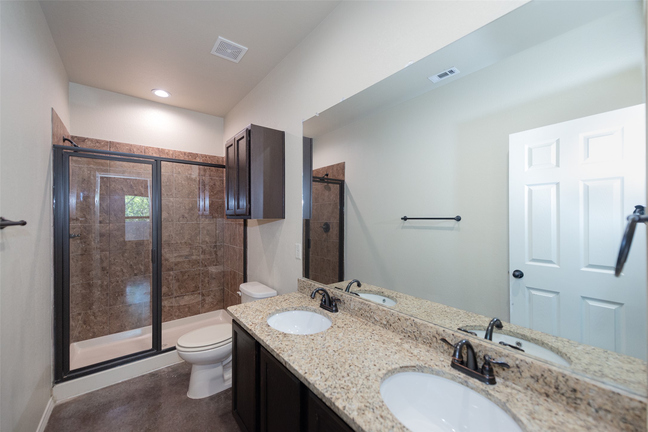 245 Joanne Loop, Unit B Buda, TX 78610 - Photo 25 of 33 Primary Bathroom, fully tiled shower, dual vanity, granite counters and recessed lighting