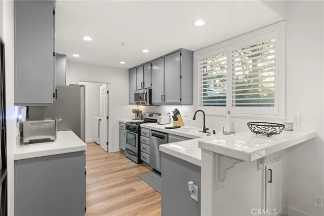 a kitchen with a sink stove and refrigerator
