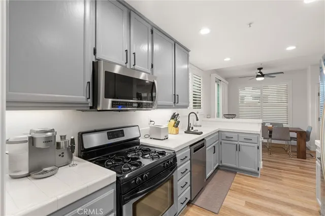 a kitchen with stainless steel appliances a sink stove and cabinets