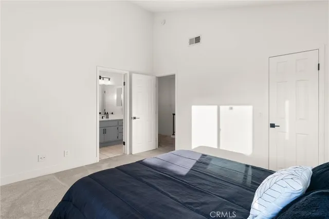 a bedroom with a bed and a couch