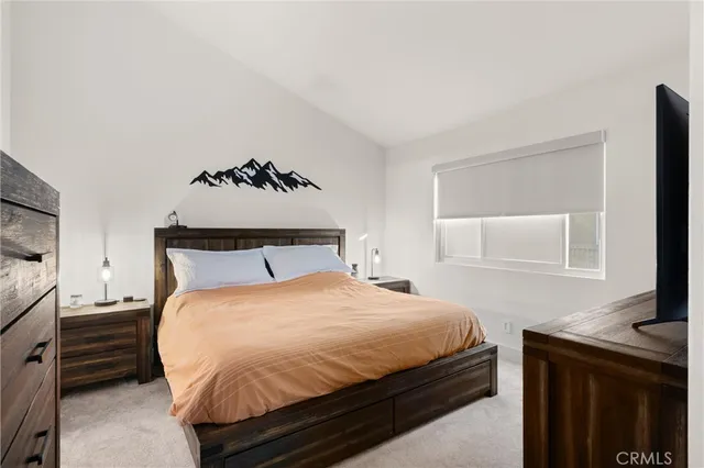 a bedroom with a bed and dresser