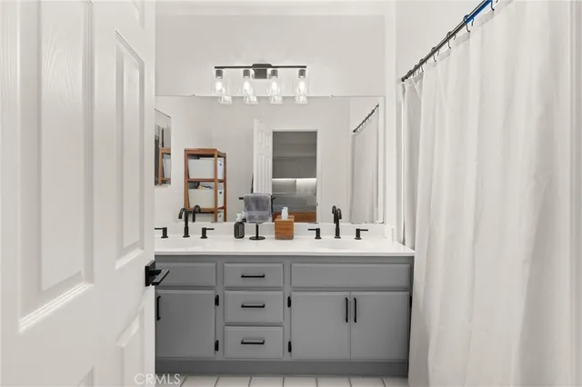 a bathroom with a double vanity sink mirror and