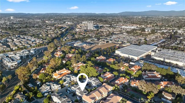 an aerial view of residential houses with city view