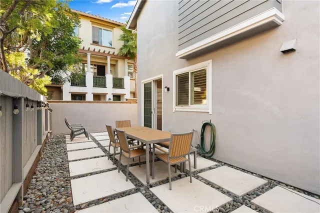 a view of a patio with a table and chairs