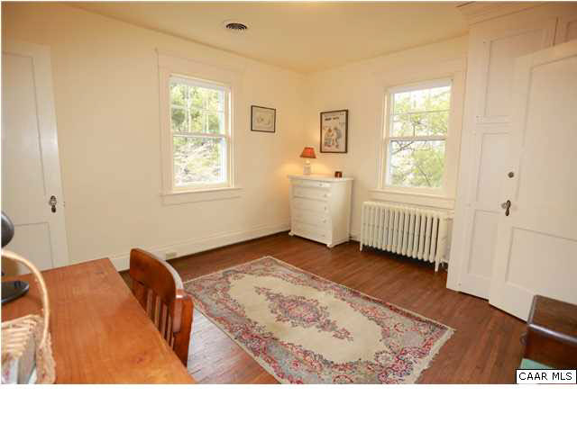 1806 Rugby Place Charlottesville, VA 22903 - Photo 23 of 34 a bedroom with a bed and wooden floor