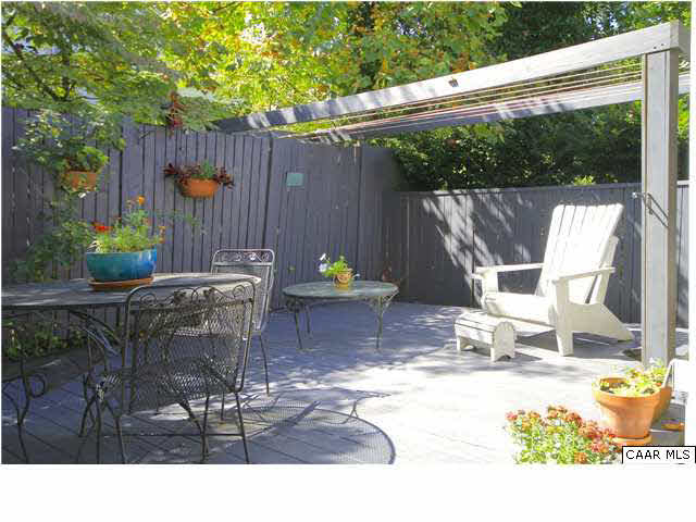 1806 Rugby Place Charlottesville, VA 22903 - Photo 3 of 34 a view of a patio with table and chairs potted plants and wooden fence