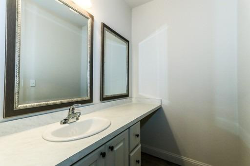 2510 112th Street, Unit A Lubbock, TX 79423 - Photo 8 of 41 a bathroom with a sink and a mirror
