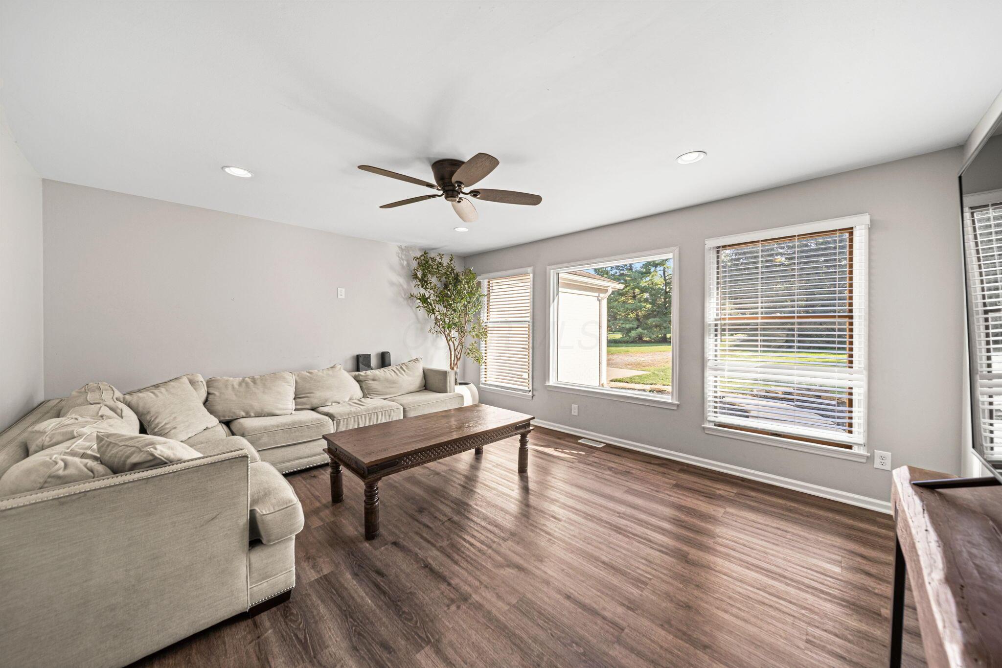 6344 Post Road Dublin, OH 43017 - Photo 10 of 45 Recessed lighting, wood-finish flooring, ceiling fan, and multiple windows